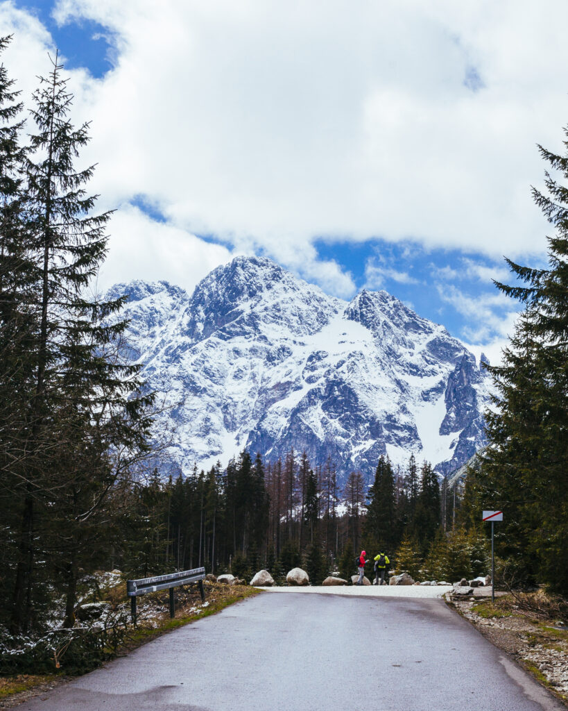 Two Tourist Standing Road Near Snowy Mountain 819x1024